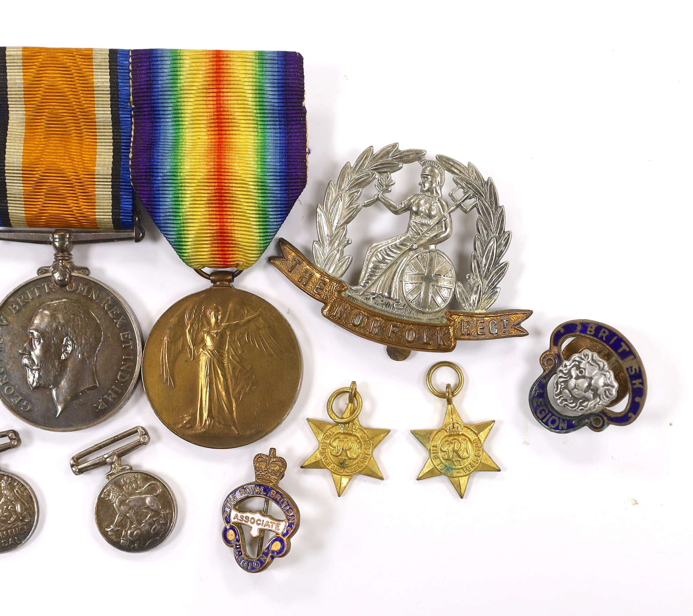 A WWI trio to Pte. W.K. Scudamore R.A.M.C. and miniatures, four WWII miniatures, five lapel badges, a silver Royal Engineers badge a Royal Sussex Reg. cap badge and a Norfolk Reg. cap badge